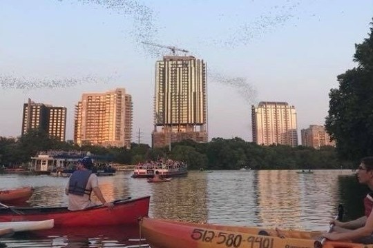 a group of people in a small boat in a body of water