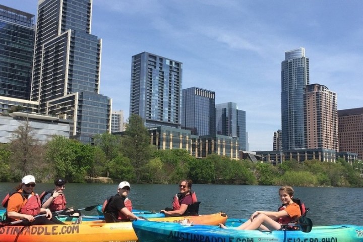 a group of people riding on the back of a boat