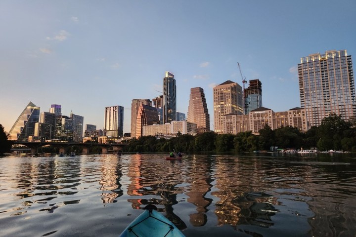 a large body of water with a city in the background